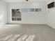 Spacious carpeted bedroom featuring natural light and a ceiling fan at 11609 N 30Th Ln, Phoenix, AZ 85029