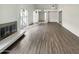 Spacious living room featuring light wood floors, a modern fireplace, and an open doorway at 11609 N 30Th Ln, Phoenix, AZ 85029