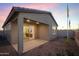Backyard featuring a covered patio, privacy wall, and desert landscaping at 14598 W Wood Dr, Surprise, AZ 85379