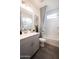 Bright bathroom features a modern vanity, decorative shower curtain, and tiled floor at 14598 W Wood Dr, Surprise, AZ 85379