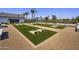 Outdoor community game area with bocce ball court, seating and shade at 14598 W Wood Dr, Surprise, AZ 85379