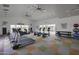 Modern gym featuring treadmills, elliptical machines, weights, and inspirational wall art near bright windows at 14598 W Wood Dr, Surprise, AZ 85379