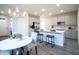 Bright kitchen features stainless steel appliances, quartz countertops, and an island with bar stools at 14598 W Wood Dr, Surprise, AZ 85379