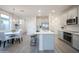 Light and bright kitchen featuring a large island, stainless appliances, and grey wood floors at 14598 W Wood Dr, Surprise, AZ 85379