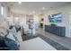 Spacious living room flowing into the kitchen, complete with a modern sofa and entertainment center at 14598 W Wood Dr, Surprise, AZ 85379