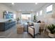 Bright living room with modern decor, comfortable seating, and sliding doors to the outside at 14598 W Wood Dr, Surprise, AZ 85379