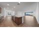 Bright and airy living room area featuring wood-look tile flooring and large sliding glass doors to the backyard at 14756 W Tether Trl, Surprise, AZ 85387