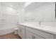 Clean and modern bathroom with a bathtub, white cabinets, and a large mirror at 14787 W El Cortez Pl, Surprise, AZ 85387