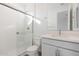Modern bathroom with a glass shower enclosure, white cabinets, and a sleek countertop at 14787 W El Cortez Pl, Surprise, AZ 85387