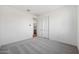 Bright bedroom featuring plush gray carpeting and neutral walls at 14787 W El Cortez Pl, Surprise, AZ 85387