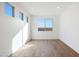 Bright bedroom featuring hardwood flooring and large windows at 14787 W El Cortez Pl, Surprise, AZ 85387