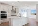 Bright kitchen with stainless steel hood and white cabinets at 14787 W El Cortez Pl, Surprise, AZ 85387
