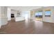 Bright, open-concept living space with wood-look tile floors that flows into the backyard at 14787 W El Cortez Pl, Surprise, AZ 85387