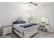 Bright bedroom featuring wood floors, a ceiling fan, neutral walls, and a vanity at 15997 W Vernon Ave, Goodyear, AZ 85395