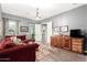 Elegant living room featuring a chandelier, hardwood floors, and cozy seating at 15997 W Vernon Ave, Goodyear, AZ 85395