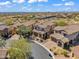 An aerial view shows a neighborhood with tile-roofed homes and desert landscaping at 1644 N Lynch --, Mesa, AZ 85207