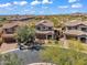 A beautiful aerial view of the desert community with desert landscaping, tile roofs, and mountain views in the distance at 1644 N Lynch --, Mesa, AZ 85207