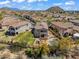 Aerial view of desert property with a putting green, pool, outdoor kitchen, and covered patio in an upscale neighborhood at 1644 N Lynch --, Mesa, AZ 85207