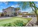 A spacious backyard features a putting green, an outdoor kitchen under a pergola, desert landscaping, and plenty of entertaining space at 1644 N Lynch --, Mesa, AZ 85207