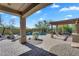 A covered backyard patio provides ample space for entertaining with a built-in grill and desert views at 1644 N Lynch --, Mesa, AZ 85207