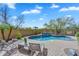 An inviting private backyard pool with brick pavers, a waterfall feature, and desert landscaping at 1644 N Lynch --, Mesa, AZ 85207