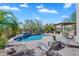 A private backyard pool with waterfall feature is surrounded by brick pavers, desert landscaping, and outdoor seating at 1644 N Lynch --, Mesa, AZ 85207