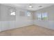 A bright bedroom has carpet flooring, a ceiling fan, and wainscotting at 1644 N Lynch --, Mesa, AZ 85207