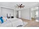 Spacious bedroom with a ceiling fan, neutral carpet, and arched doorway to the ensuite bathroom at 1644 N Lynch --, Mesa, AZ 85207