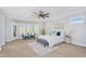 A large bedroom with neutral carpet, recessed lighting, and sitting area next to large windows at 1644 N Lynch --, Mesa, AZ 85207