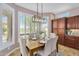 Cozy dining area featuring large windows, modern lighting, and a nearby kitchen with ample storage at 1644 N Lynch --, Mesa, AZ 85207