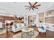 Spacious living room featuring a ceiling fan, hardwood floors, and an open layout to the kitchen at 1644 N Lynch --, Mesa, AZ 85207