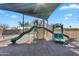 Community playground with slides, climbing features, and a bench nearby at 1644 N Lynch --, Mesa, AZ 85207