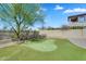 Backyard putting green with artificial turf and desert landscaping at 1644 N Lynch --, Mesa, AZ 85207