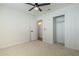 A standard bedroom with a closet, ensuite bathroom and neutral-colored carpeting at 1712 W 11Th Ave, Apache Junction, AZ 85120