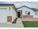 Close up view of home showcasing brick accents, a two car garage and manicured yard at 1712 W 11Th Ave, Apache Junction, AZ 85120