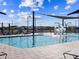 Community zero entry pool featuring a splash pad, shade structures, and lounge chairs at 17687 W Amber Dr, Goodyear, AZ 85338