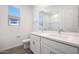 Bright bathroom with double vanity, large mirror, wood look floors and plentiful natural light at 18447 W Mohave St, Goodyear, AZ 85338