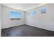 An empty bedroom featuring tiled floors, recessed lighting and three bright, sunny windows at 18447 W Mohave St, Goodyear, AZ 85338