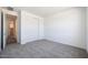 Bright bedroom featuring neutral carpet and a closet with bi-fold doors at 18447 W Mohave St, Goodyear, AZ 85338