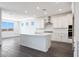A gorgeous kitchen featuring white cabinets, a center island, stainless steel appliances and a white backsplash at 18447 W Mohave St, Goodyear, AZ 85338