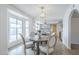 Bright dining area featuring a round wooden table, stylish chairs, and a view of the pool at 1915 W Nopal Cir, Mesa, AZ 85202