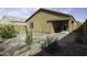 Desert landscaped backyard with large patio and covered porch at 1973 N Lewis Pl, Casa Grande, AZ 85122