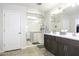 Modern bathroom with a glass shower, a bench, and a double vanity with dark wood cabinets at 1973 N Lewis Pl, Casa Grande, AZ 85122