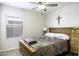 Cozy bedroom featuring a ceiling fan, a window with blinds, and a quilt-covered bed at 1973 N Lewis Pl, Casa Grande, AZ 85122