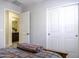 Bedroom with sliding closet doors next to a door leading to the bathroom at 1973 N Lewis Pl, Casa Grande, AZ 85122