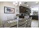 Dining room boasts dark wood cabinets, modern appliances, and a decorative tapestry at 1973 N Lewis Pl, Casa Grande, AZ 85122