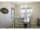 Cozy dining area with a wooden table, comfortable chairs, and a stylish light fixture at 1973 N Lewis Pl, Casa Grande, AZ 85122