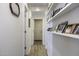 Bright hallway featuring wood-look tile and built-in shelving for displaying photos at 1973 N Lewis Pl, Casa Grande, AZ 85122