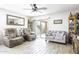 Bright living room featuring tile flooring, comfortable seating, and a sliding glass door to the patio at 1973 N Lewis Pl, Casa Grande, AZ 85122
