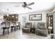 An open-concept living room and kitchen area with modern furnishings and a ceiling fan at 1973 N Lewis Pl, Casa Grande, AZ 85122
